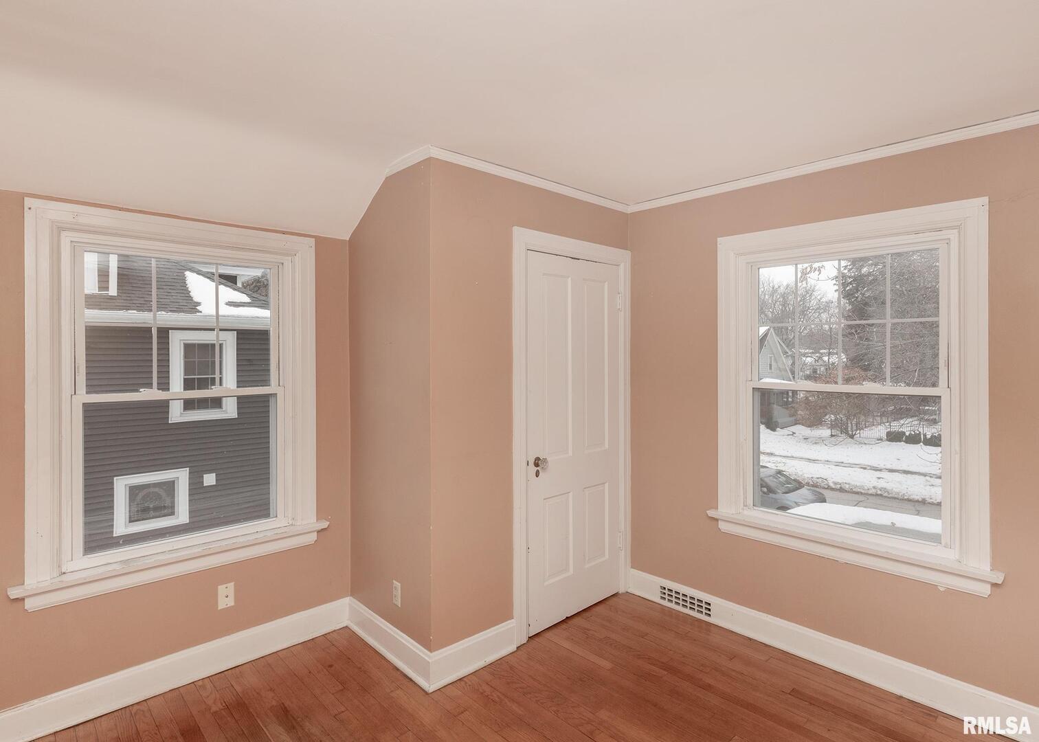 2416 12th Street Moline, IL 61265 - Photo 29 of 41 a view of an empty room with wooden floor and a window