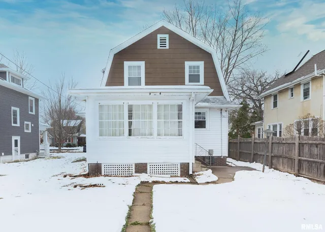 a view of a house with snow on the road