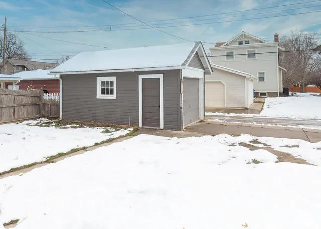 a view of a house with snow on the road