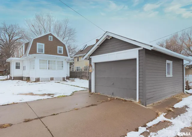 a view of garage yard and front view of a house