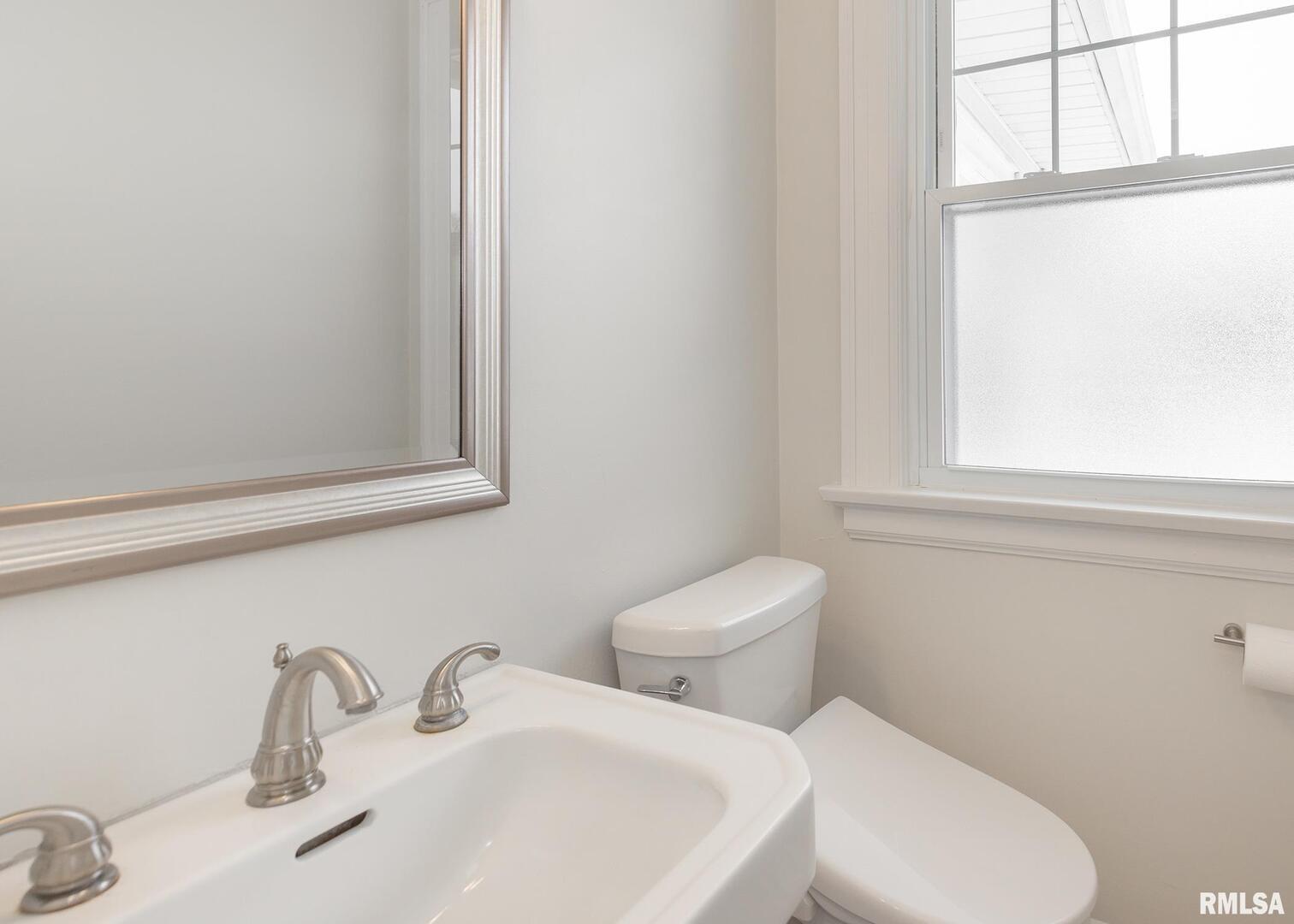 2416 12th Street Moline, IL 61265 - Photo 10 of 41 a white toilet sitting next to a bathroom sink
