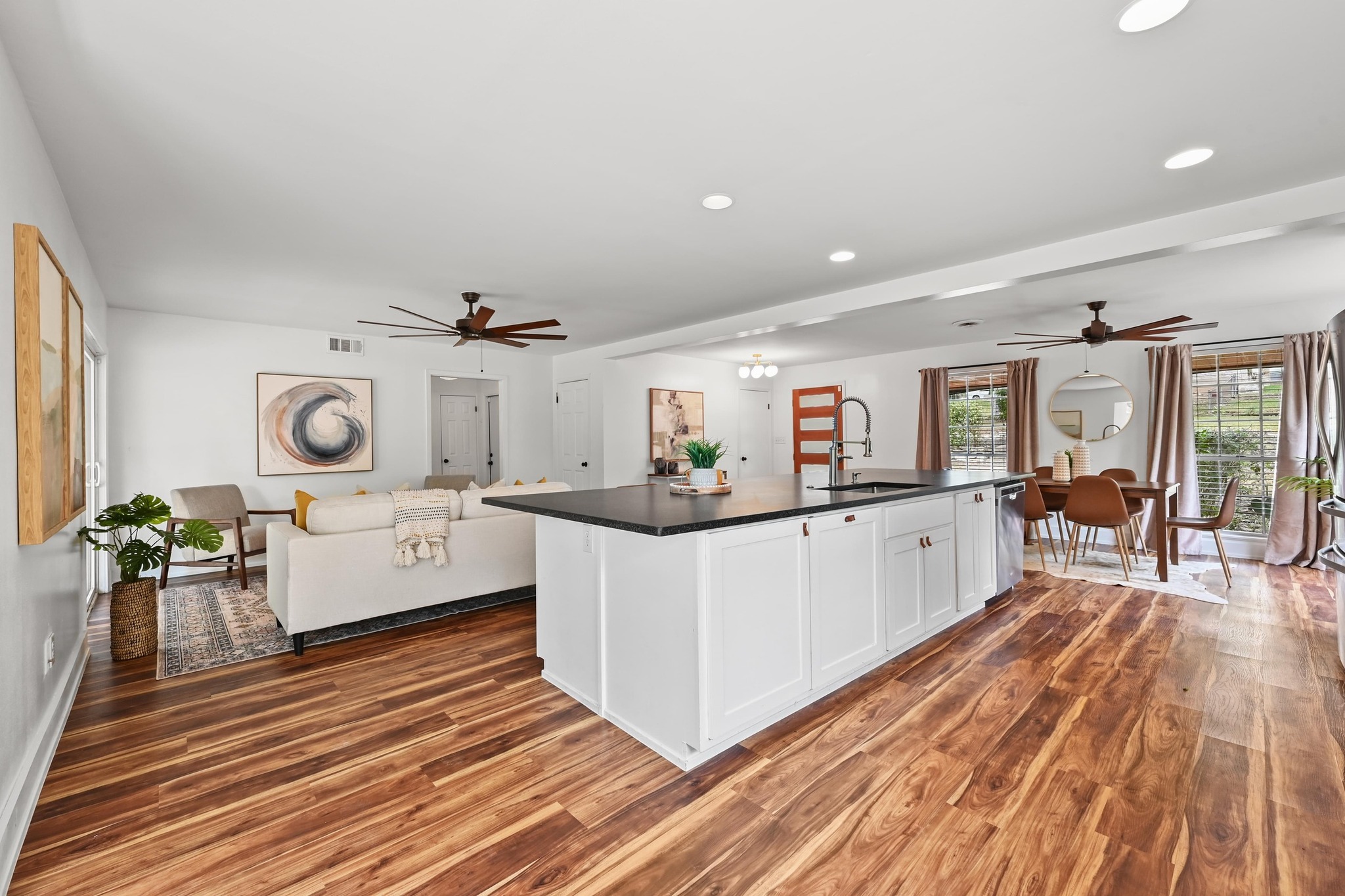 3405 Santa Fe Drive Austin, TX 78741 - Photo 22 of 23 Kitchen featuring ceiling fan, open floor plan, dark countertops, recessed lighting, and white cabinetry