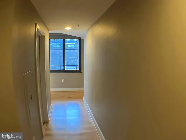a view of hallway with wooden floor