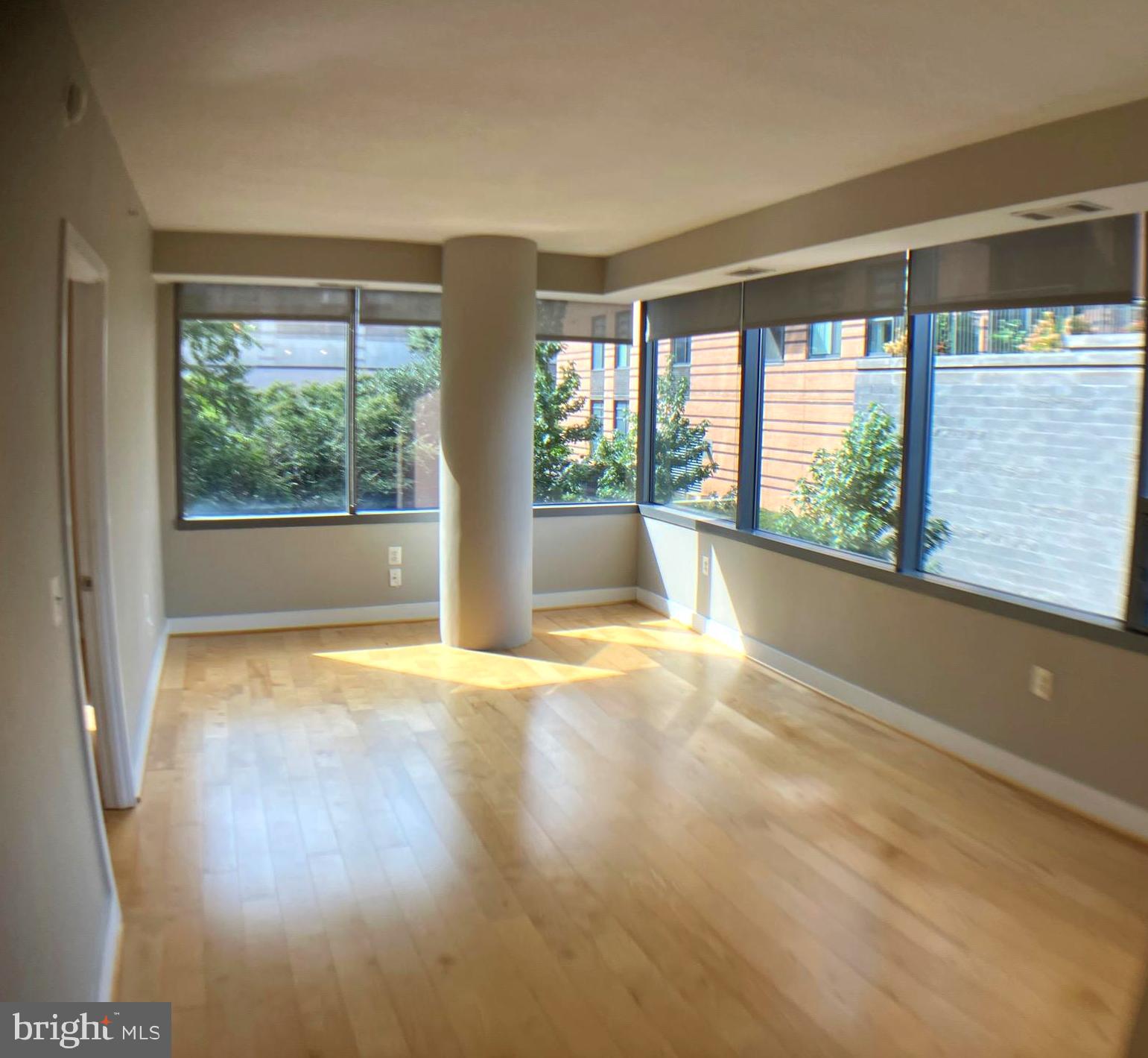 2001 15th Street North, Unit 319 Arlington, VA 22201 - Photo 19 of 19 a view of an empty room with wooden floor and a window
