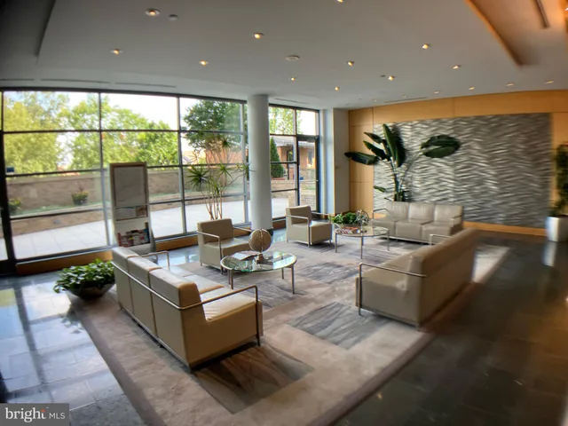 a living room with fireplace furniture and a large window