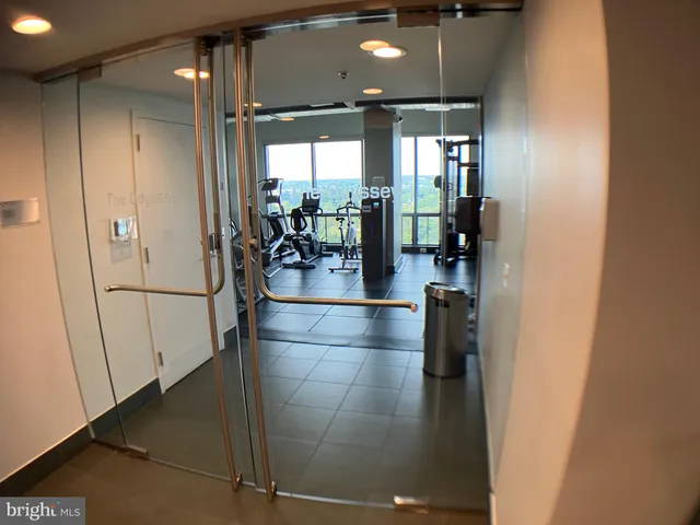 a view of a hallway with dining area and chandelier