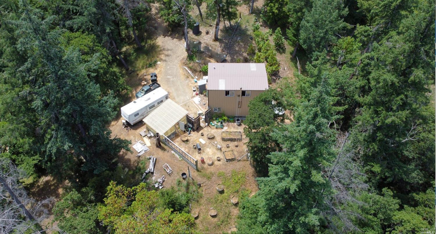 an aerial view of a house with a yard