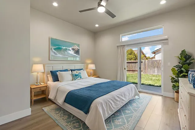 a bedroom with a large bed and a large window