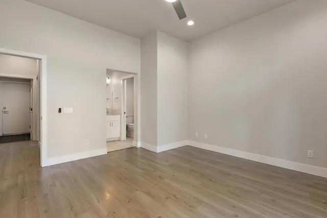 a view of an empty room with wooden floor