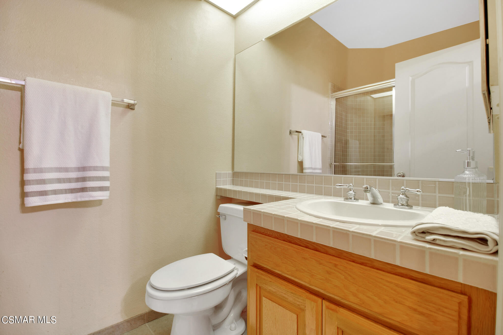 11603 Pinedale Road Moorpark, CA 93021 - Photo 39 of 54 a bathroom with a granite countertop toilet sink and mirror