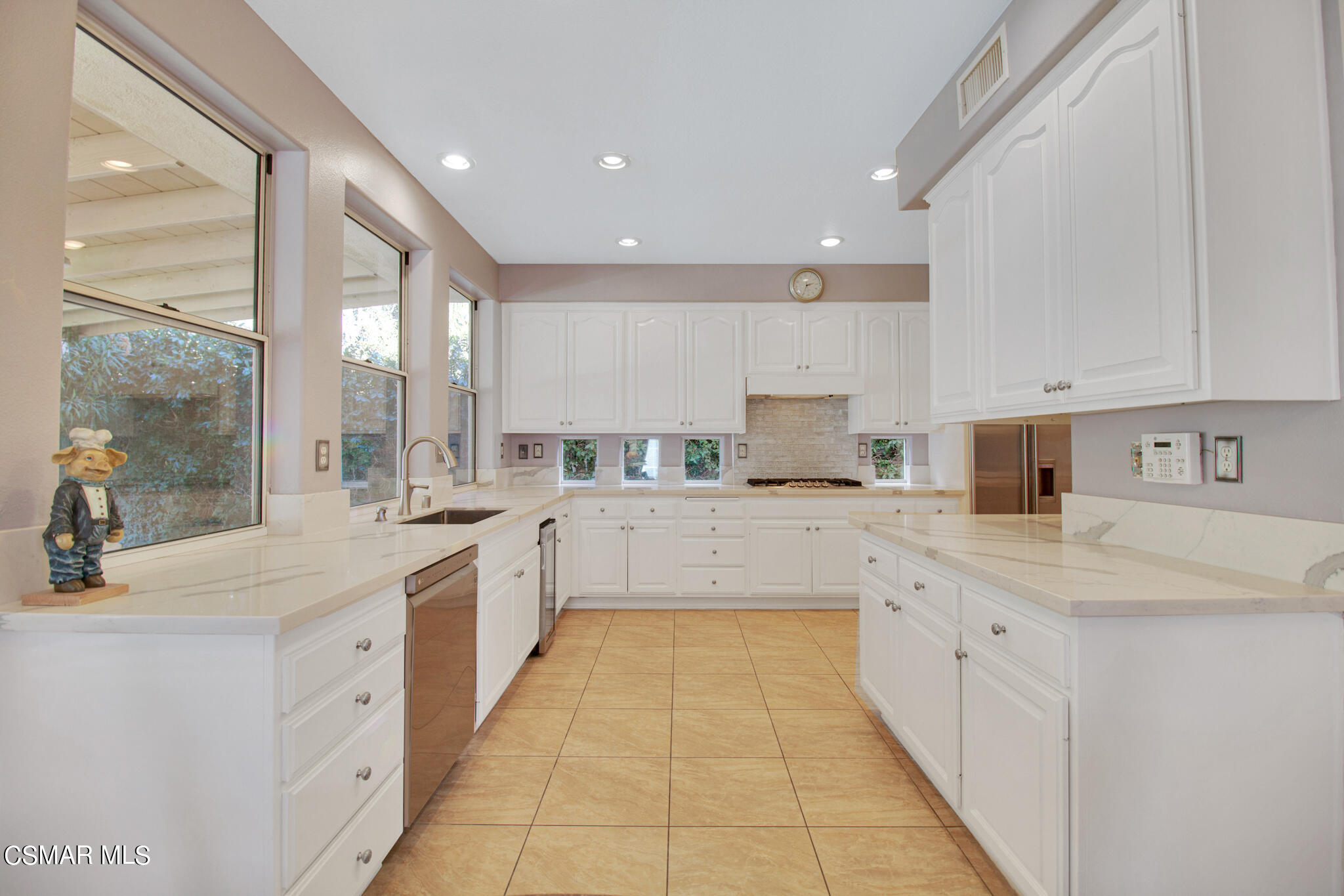 11603 Pinedale Road Moorpark, CA 93021 - Photo 5 of 54 a large white kitchen with a sink and cabinets