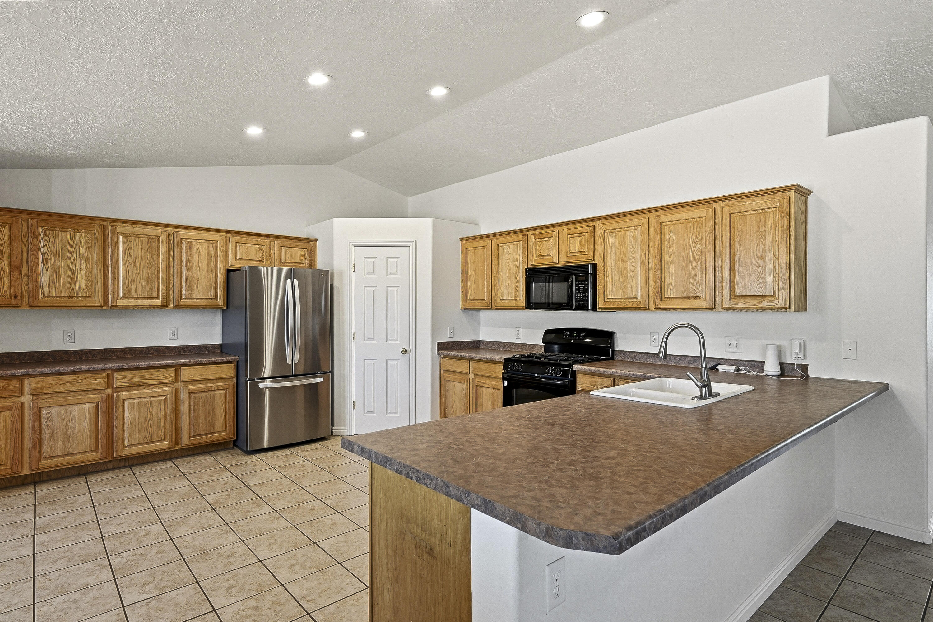 4510 North Half Mile Road Cedar City, UT 84721 - Photo 11 of 48 The spacious kitchen offers ample cabinet and countertop space, providing plenty of room for preparing meals with ease.
