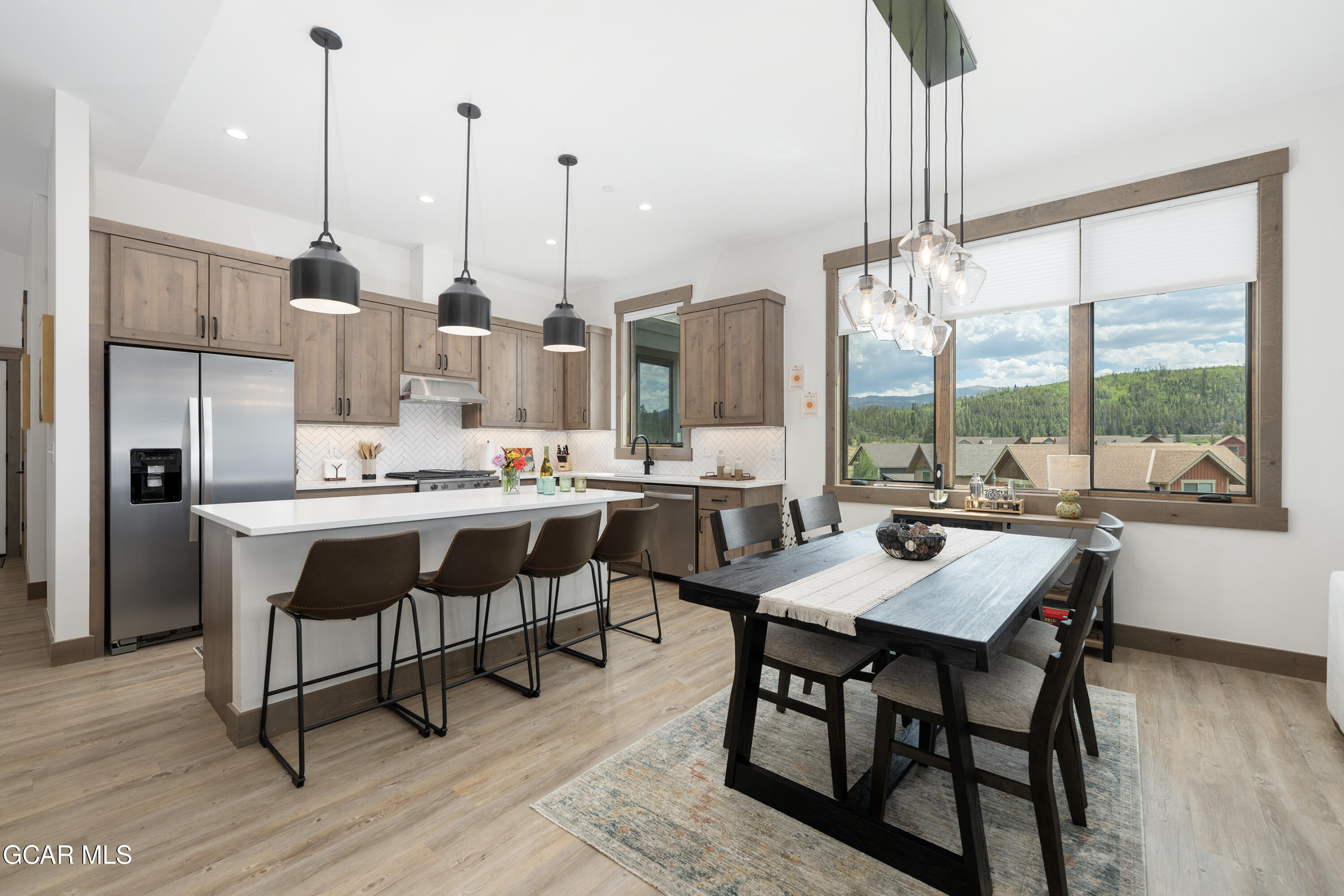 96 Meadow Trail, Unit G304 Fraser, CO 80442 - Photo 10 of 37 a dining room filled with furniture and a floor to ceiling window