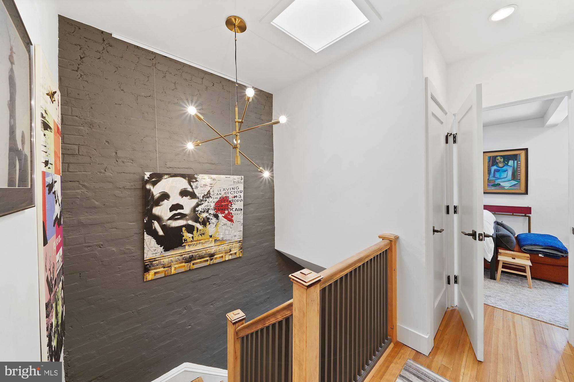 3213 Adams Mill Road Northwest Washington, DC 20010 - Photo 27 of 43 Exposed brick walls and beautiful light fixtures