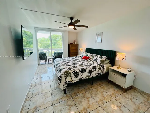 a bedroom with a bed and large flat screen tv