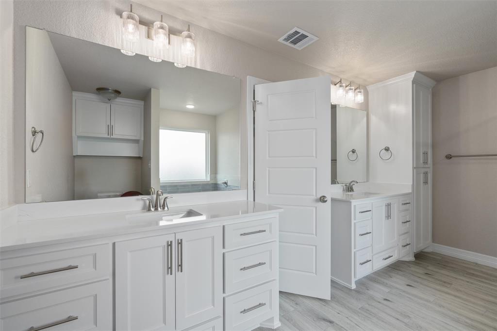 1341 Promised Land Road Hewitt, TX 76643 - Photo 12 of 29 Bathroom featuring twin vanities with white cabinetry and integrated sinks