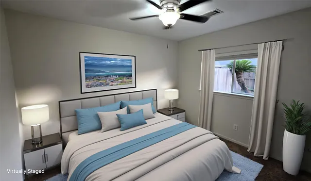 a bedroom with a bed and a potted plant