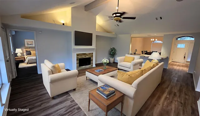 a living room with furniture fireplace and a flat screen tv