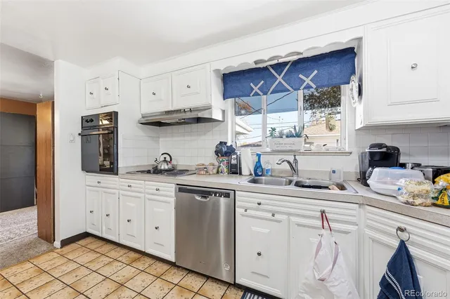 a kitchen with stainless steel appliances granite countertop a sink and cabinets