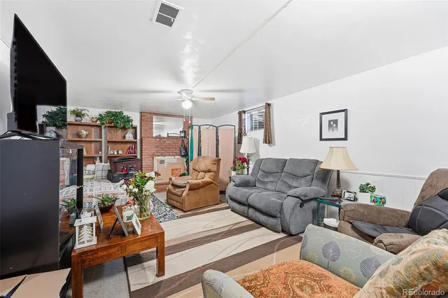 a living room with furniture fireplace and a flat screen tv