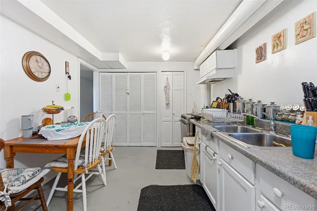 a kitchen with stainless steel appliances granite countertop a dining table and chairs