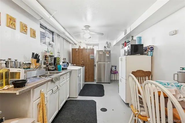 a kitchen with refrigerator and cabinets