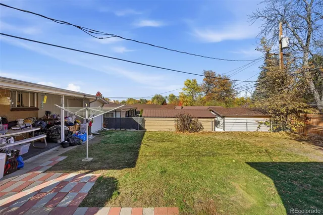 a view of a house with big yard and potted plants