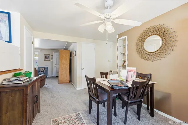 a view of a dining room with furniture and chandelier