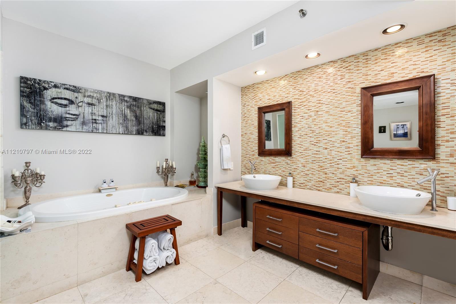 450 Alton Road, Unit 1404 Miami Beach, FL 33139 - Photo 13 of 33 a bathroom with a tub double sink and mirror