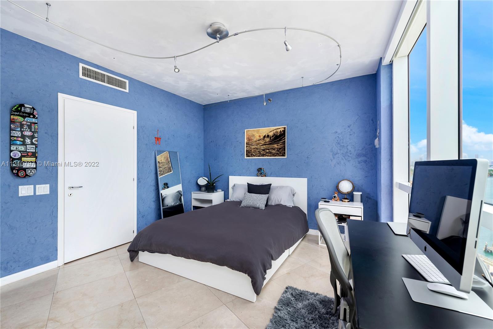 450 Alton Road, Unit 1404 Miami Beach, FL 33139 - Photo 15 of 33 a living room with a bed furniture and a flat screen tv