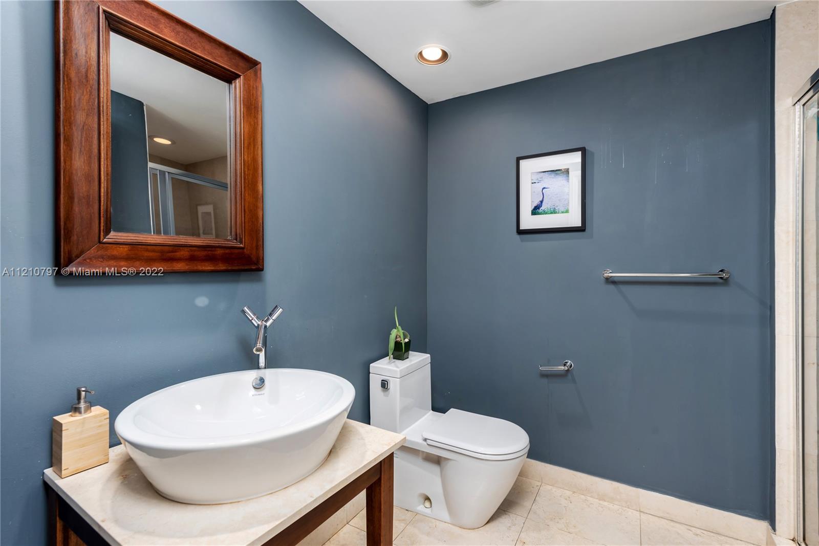 450 Alton Road, Unit 1404 Miami Beach, FL 33139 - Photo 18 of 33 a bathroom with a sink a toilet and mirror