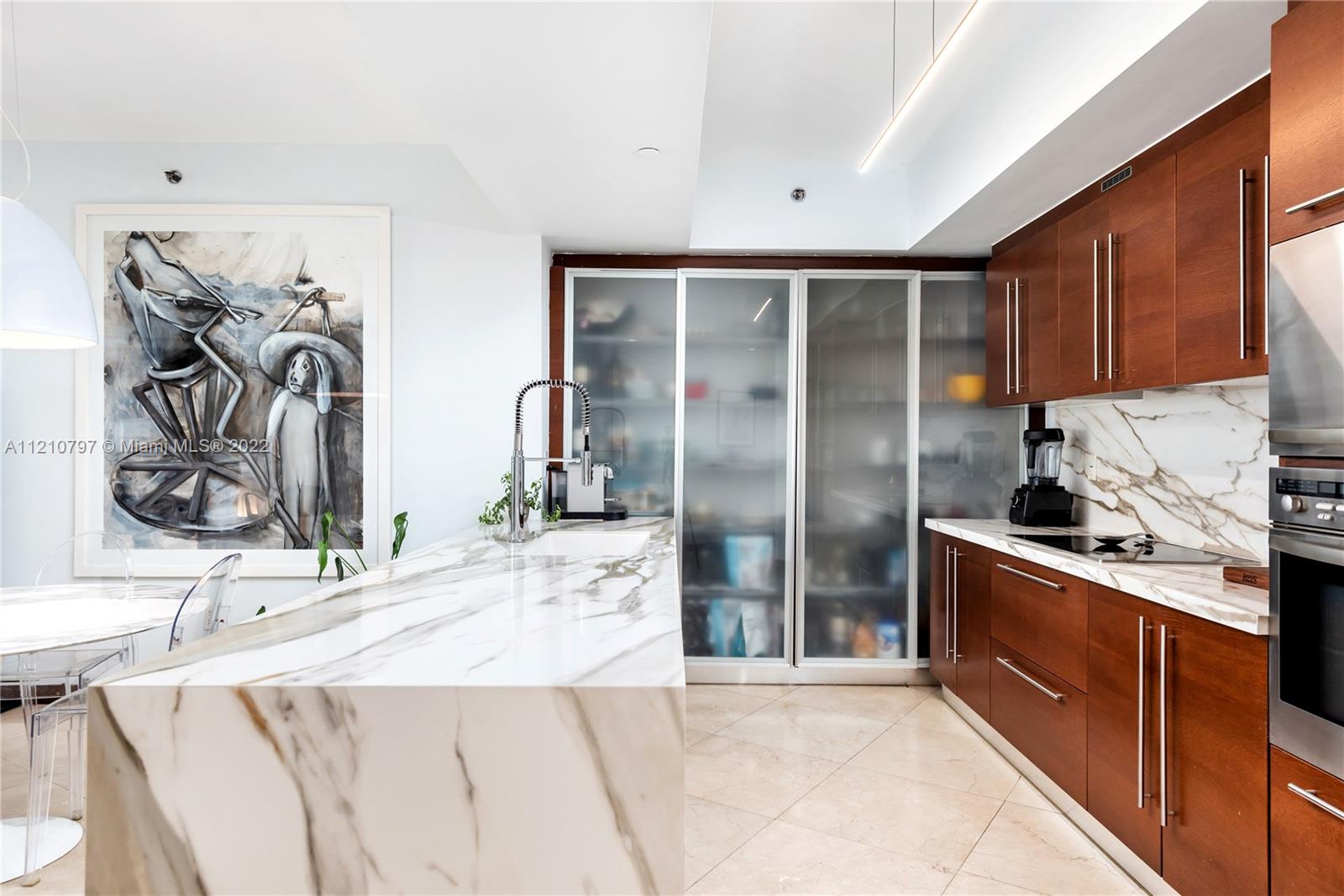 450 Alton Road, Unit 1404 Miami Beach, FL 33139 - Photo 7 of 33 a kitchen with stainless steel appliances kitchen island granite countertop a refrigerator and a sink