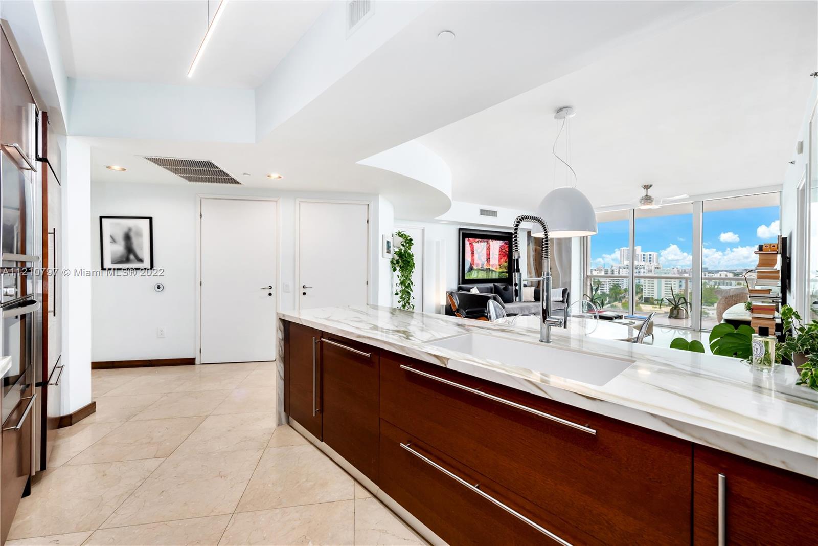 450 Alton Road, Unit 1404 Miami Beach, FL 33139 - Photo 8 of 33 a large kitchen with kitchen island a sink stainless steel appliances and cabinets
