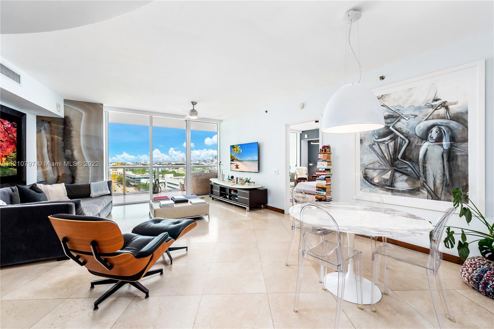 450 Alton Road, Unit 1404 Miami Beach, FL 33139 - Photo 10 of 33 a living room with furniture a fireplace and flat screen tv