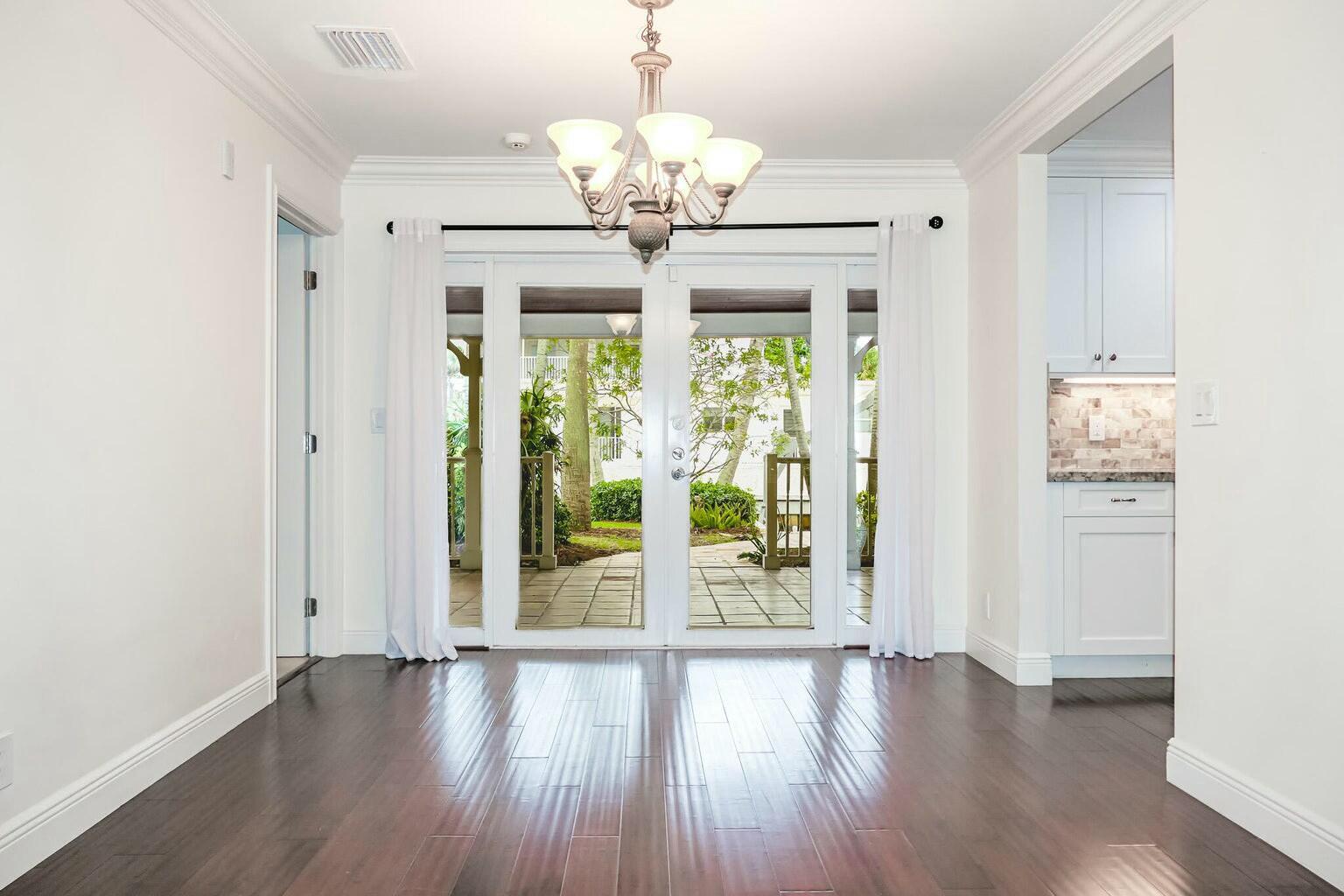 18014 Perigon Way Jupiter, FL 33458 - Photo 9 of 35 a view of an empty room with wooden floor and a window