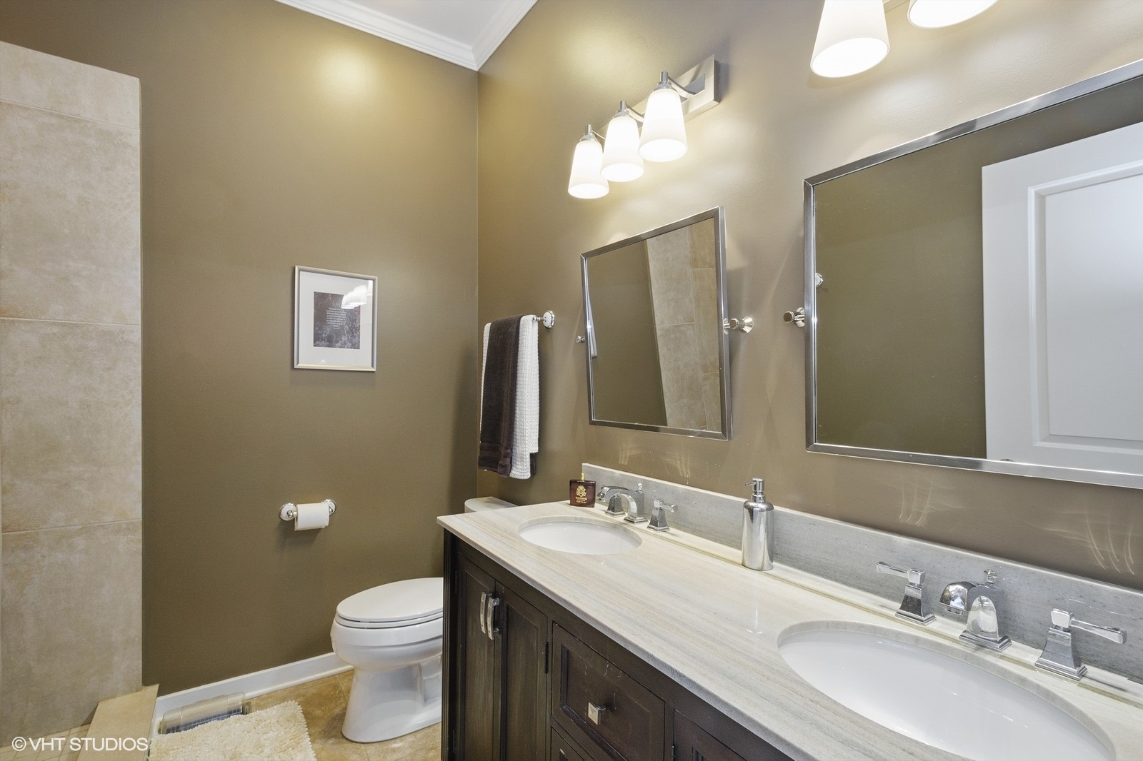 1244 West Monroe Street, Unit 4 Chicago, IL 60607 - Photo 12 of 16 a bathroom with a double vanity sink toilet and a mirror