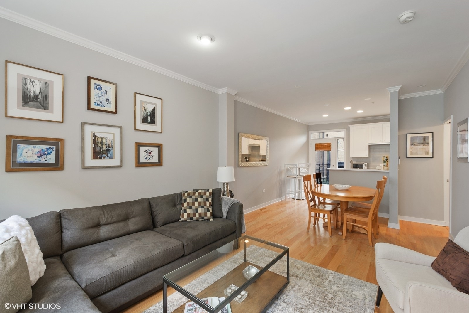1244 West Monroe Street, Unit 4 Chicago, IL 60607 - Photo 5 of 16 a living room with furniture wooden floor and a kitchen