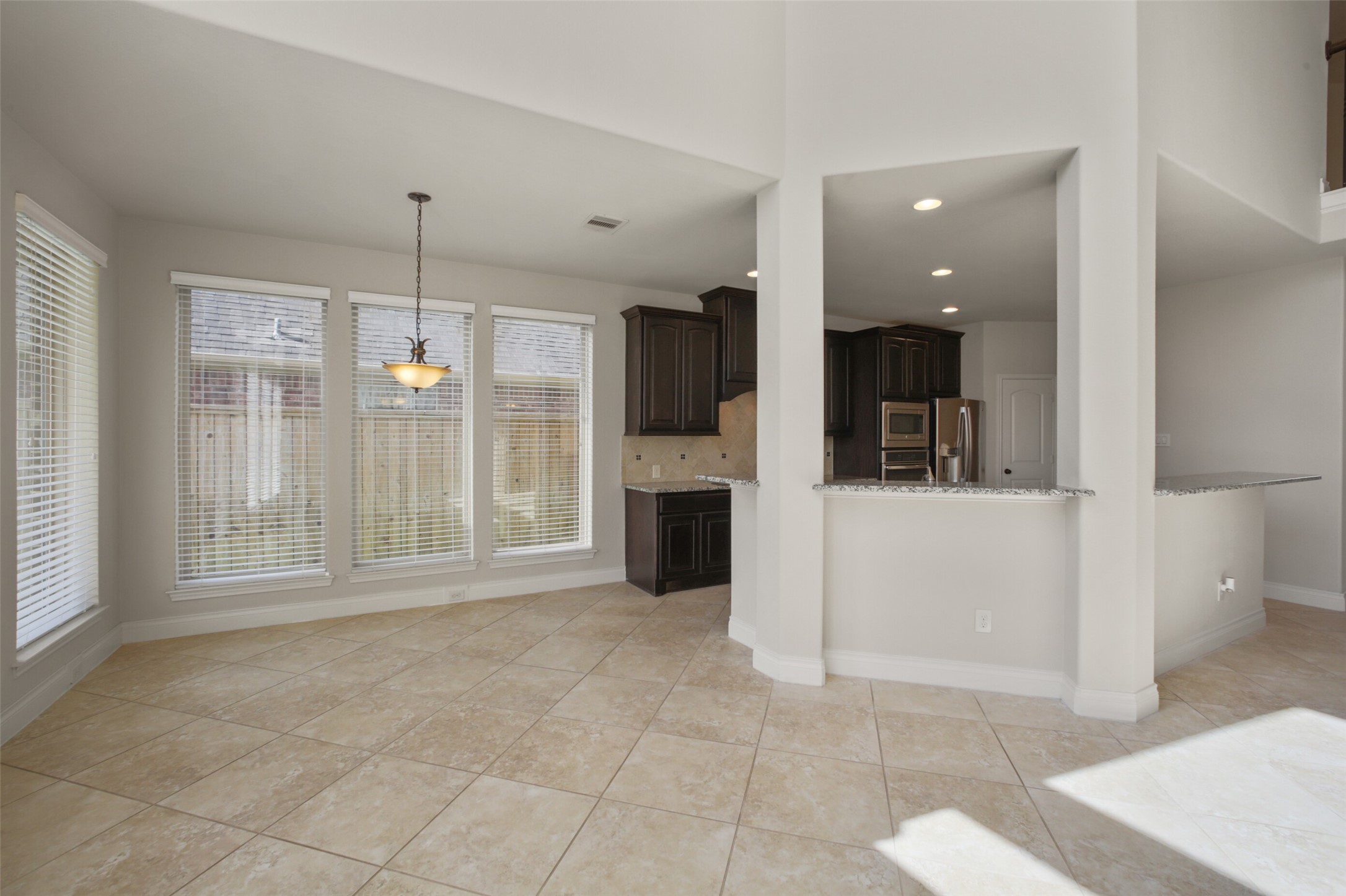 2707 River Run Road Missouri City, TX 77459 - Photo 13 of 45 a view of a big room with windows and chandelier