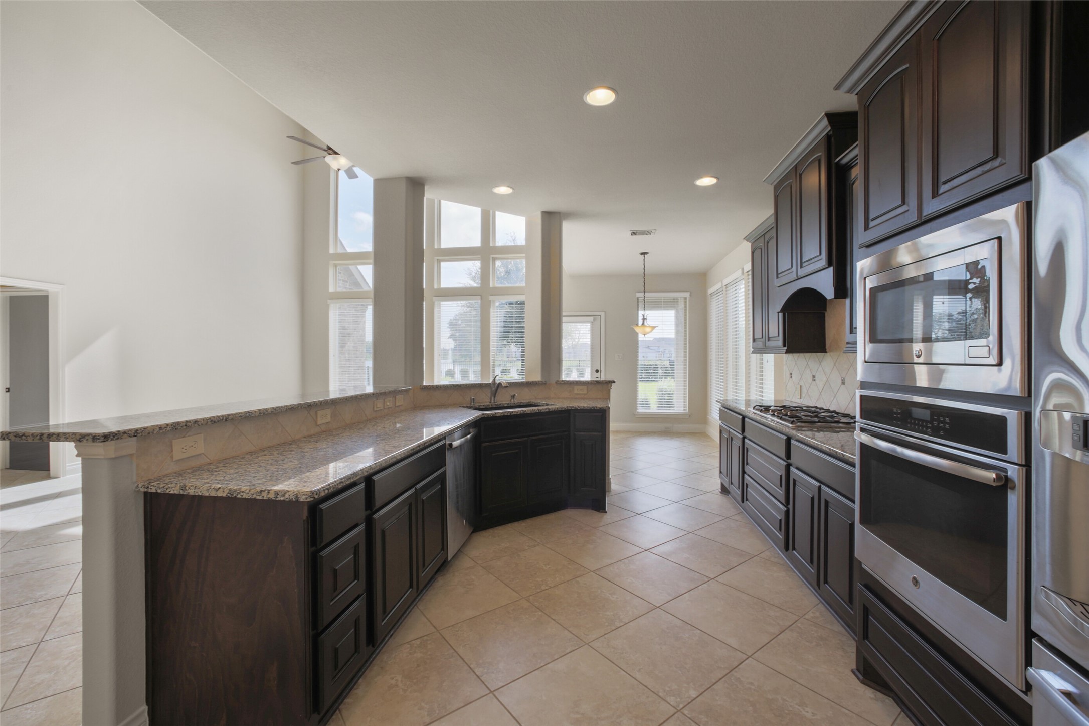 2707 River Run Road Missouri City, TX 77459 - Photo 14 of 45 a kitchen with stainless steel appliances granite countertop a stove a sink and a refrigerator