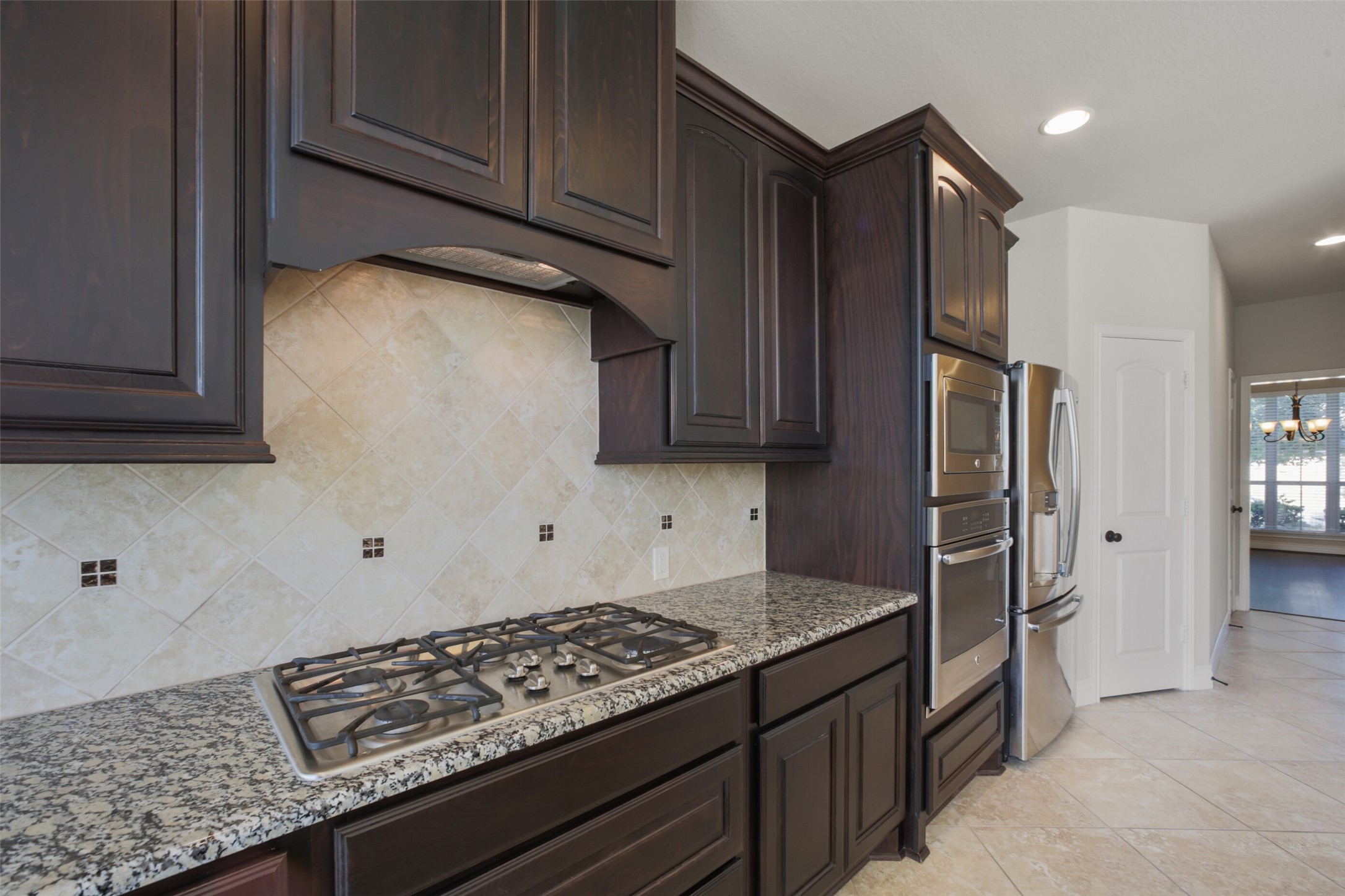 2707 River Run Road Missouri City, TX 77459 - Photo 15 of 45 a kitchen with granite countertop cabinets and refrigerator