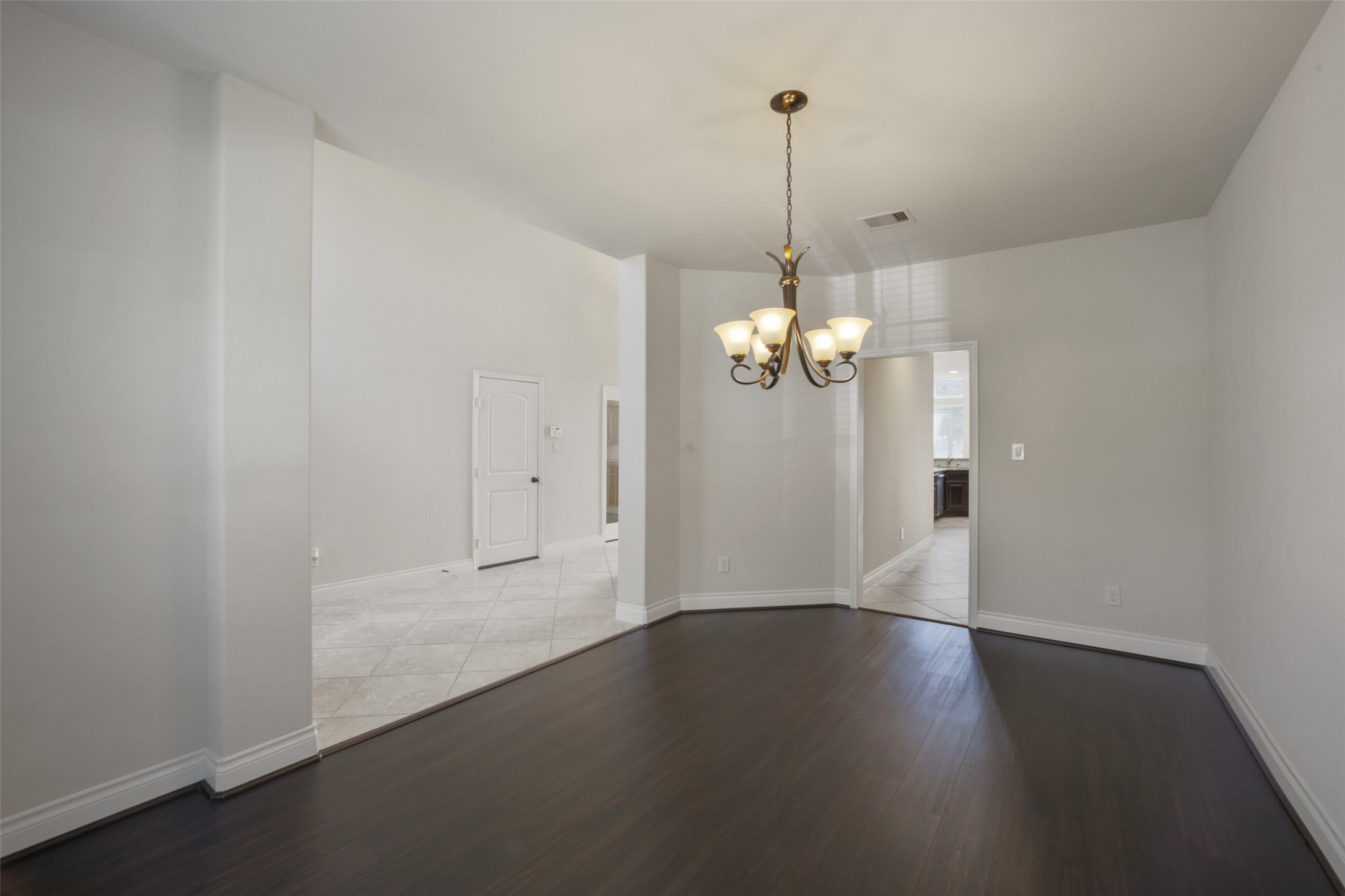 2707 River Run Road Missouri City, TX 77459 - Photo 17 of 45 a view of a room with wooden floor chandelier and a window