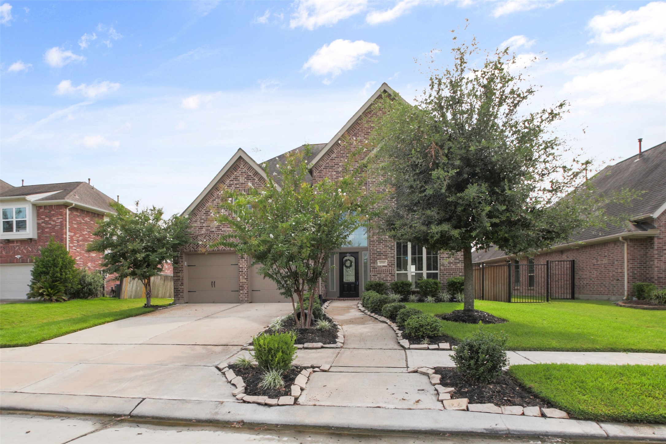 2707 River Run Road Missouri City, TX 77459 - Photo 2 of 45 a front view of a house with a yard and potted plants
