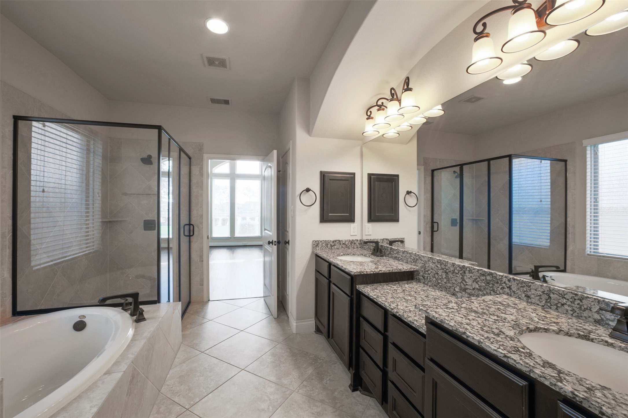 2707 River Run Road Missouri City, TX 77459 - Photo 22 of 45 a spacious bathroom with a granite countertop sink a large mirror and a bathtub