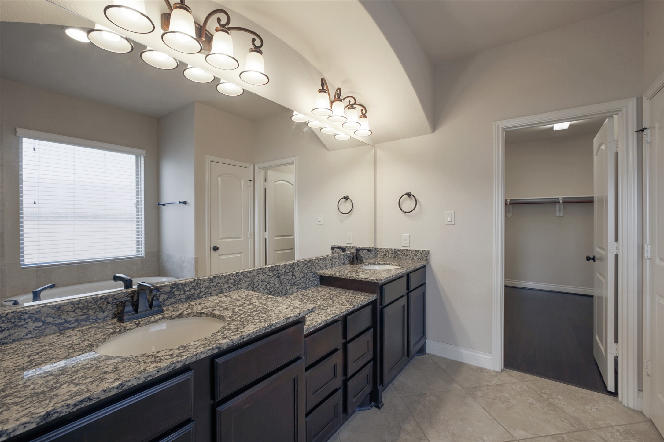 2707 River Run Road Missouri City, TX 77459 - Photo 24 of 45 a bathroom with a granite countertop sink a light fixture and a mirror