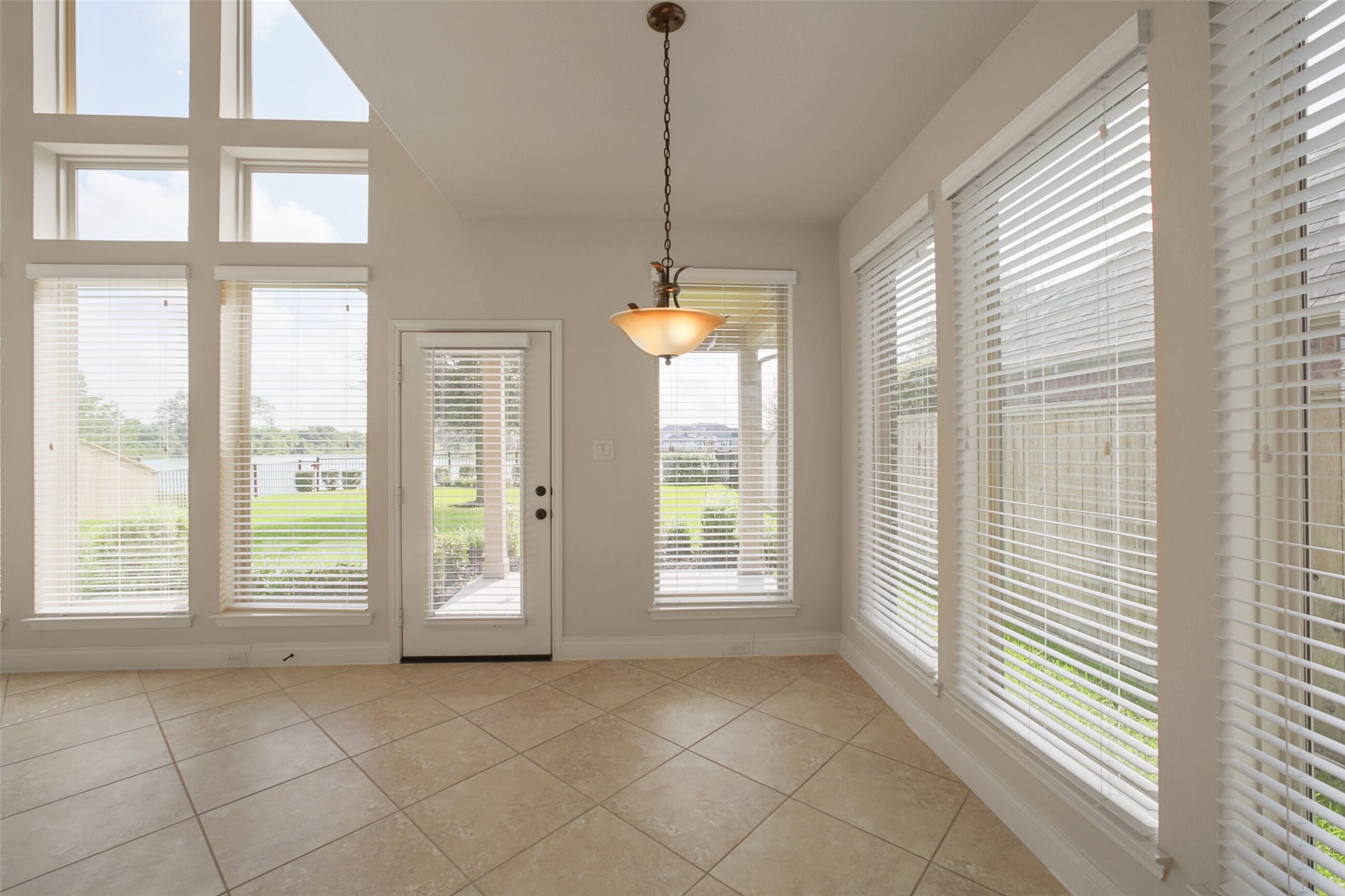 2707 River Run Road Missouri City, TX 77459 - Photo 27 of 45 a view of an empty room with a window and chandelier