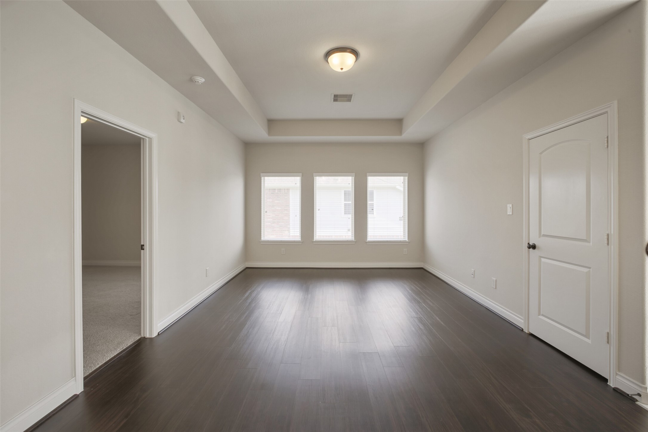 2707 River Run Road Missouri City, TX 77459 - Photo 30 of 45 an empty room with wooden floor and windows