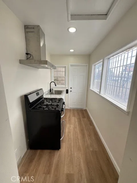11222 Concert Street El Monte, CA 91731 - Photo 11 of 15 a kitchen with a stove and a refrigerator