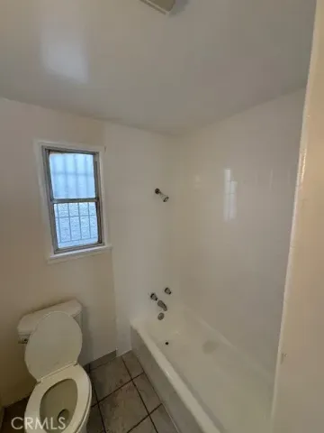 a bathroom with a toilet a sink and bathtub