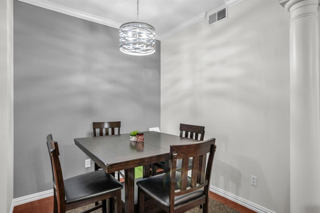 2524 Preston Road, Unit 808 Plano, TX 75093 - Photo 12 of 31 Dedicated dining area featuring a contemporary chandelier with a spiral design, crown molding, and wood flooring. Can be used as a study!
