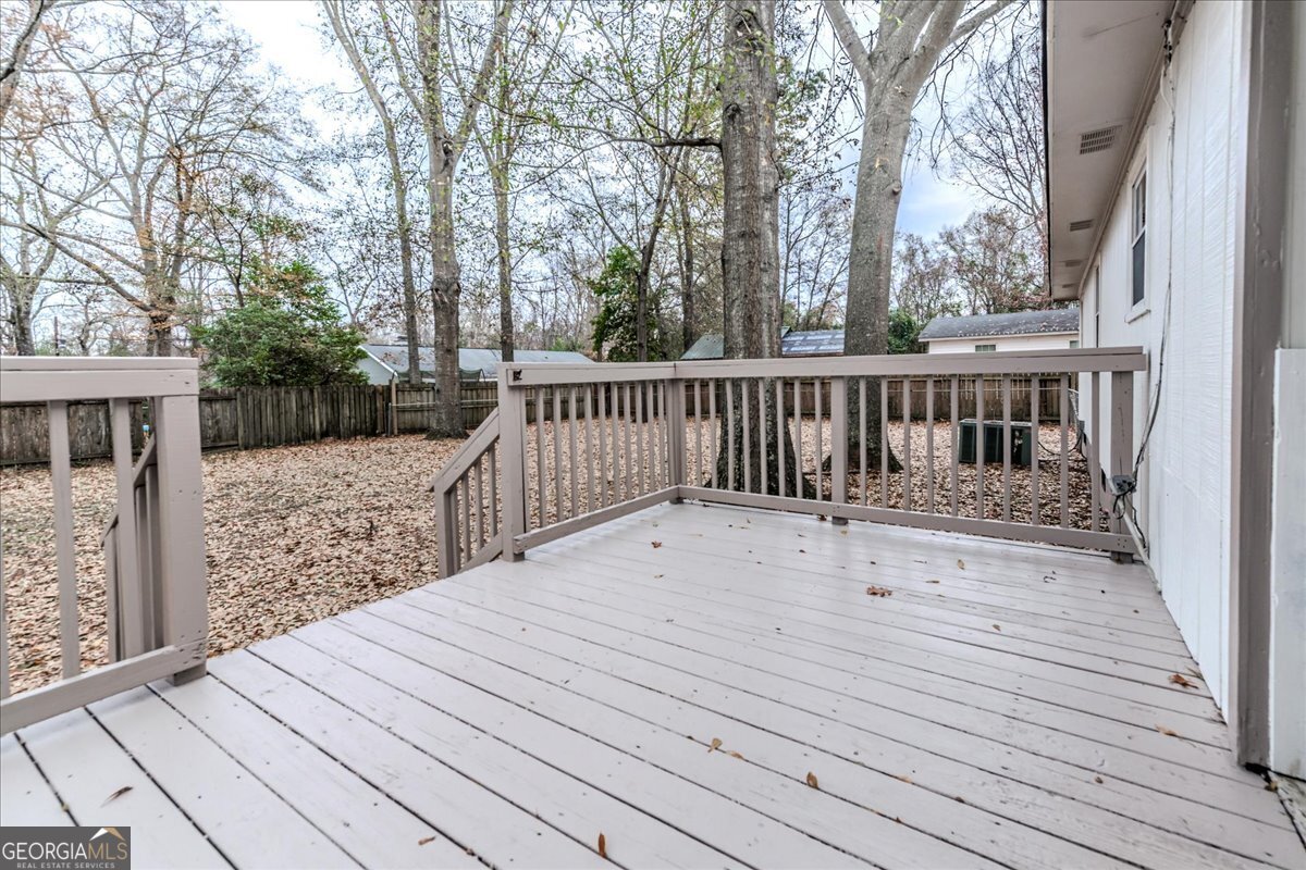 111 Collins Street Byron, GA 31008 - Photo 16 of 26 a view of balcony with wooden floor and fence
